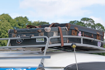 Vintage vehicle roof rack with suitcases