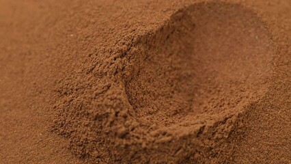 Wall Mural - Cinnamon powder in golden spoon, close up