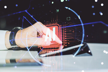Poster - Double exposure of creative artificial Intelligence abbreviation and hand working with a digital tablet on background. Future technology and AI concept