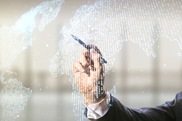 Poster - Man hand with pen working with abstract creative world map interface on blurred office background, international trading concept. Multiexposure