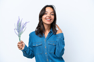 Wall Mural - Young hispanic woman holding lavender isolated on white background giving a thumbs up gesture