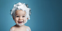 Little Smiling Baby Boy With Big Soap Foam On Her Head In Her Hair On A Blue Background. Copy Space
