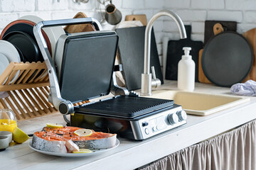 Wall Mural - fresh trout steak ready to be cooked on electric grill in the kitchen