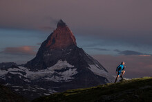 Alpine Trail Running At Dusk With Mountain Backdrop