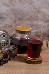 Wall Mural - tea in a cup ,a cup filled with tea next to a jug with tea and dry tea poured from the jar,