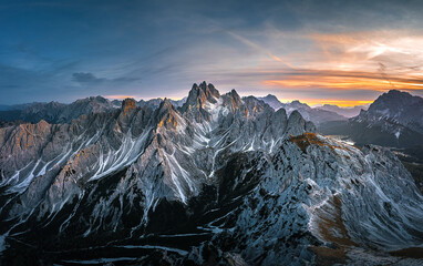 Stunning sunset with colorful sky at Italian Dolomites. Impressive Cadini di Misurina mountain range in autumn colors. 
