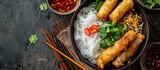 Fototapeta  - Top view of Asian food: Cold rice vermicelli with sauce, paired with fried spring rolls in a bowl.