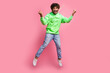 Full length size photo of awesome positive sportive guy jumping raised fists up active team member isolated on pink color background