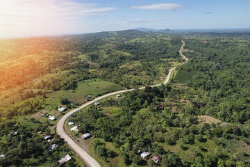 Wall Mural - Long road in green hills background