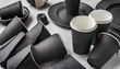 Black paper cups lying in the background. Mockups of disposable coffee and tea glasses