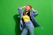 Photo of pretty excited lady wear denim jacket smiling hands arms hat empty space isolated green color background