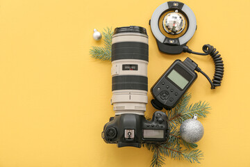 Wall Mural - Photographer's equipment with Christmas decor on yellow background