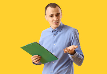 Sticker - Confused young man with clipboard on yellow background