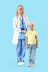 Canvas Print - Little Asian girl after chemotherapy with doctor on blue background. Childhood cancer awareness concept