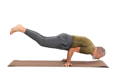 Wall Mural - Sporty mature man doing yoga on mat against white background