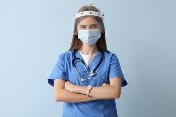 Wall Mural - Female doctor in protective masks on blue background