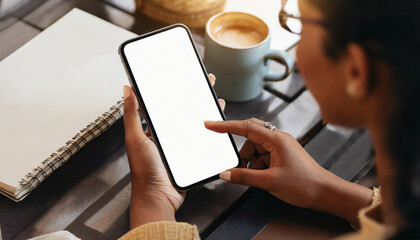 woman's hand holding mobile phone at cafe, depicting modern connectivity and technology usage