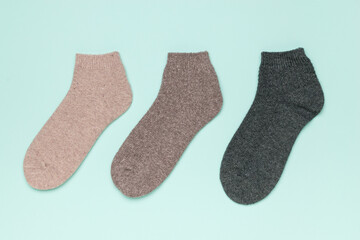 Wall Mural - Three short multi-colored socks on a blue background.