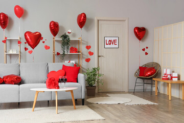 Poster - Interior of festive living room with grey sofa, heart-shaped balloons and glasses of wine on coffee table. Valentine's Day celebration