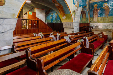 Wall Mural - Wooden benches in the main hall of the Greek Orthodox Church of Annunciation in Nazareth old city in northern Israel