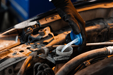 Close up of hands of auto mechanic working in a garage