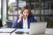 © snowing12 - Asian businesswomen using smartphone to talking with colleague and typing on keyboard laptop to researching business data while analyze investment and market stock of new startup in outside office