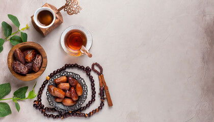 Wall Mural - Ramadan food and drinks concept. Ramadan wood rosary, tea, and dates fruits on light background