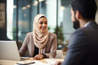 © Uzair - Asian Muslim female hr manager wearing hijab giving interview