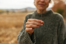 Mature Woman Holding Twig In Hand