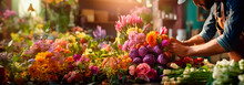 Close-up Of Florist's Hands At Work, Making Colorful Bouquet Compositions From Fresh Flowers On Background Of Various Flowers,Rose,Lily,Tulip In Warm Sunligh. Floristics. A Gift. Banner. Copy Space