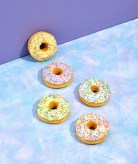 Wall Mural - Some yummy, sweet and beautiful doughnuts with different colored glazes and sprinkles. Happy birthday concept or holiday weekend.