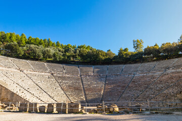 Wall Mural - Ancient Theatre of Epidaurus is theatre in Greek city of Epidaurus, located on southeast end of sanctuary dedicated to the ancient Greek God of medicine, Asclepius in Peloponnese, Greece