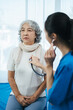 © NINENII - Doctor with stethoscope examining elderly patient with examination, presenting symptoms and recommending treatment, healthcare and medical concept.