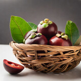 fresh kokum or garcinia indica fruit from india isolated over white or in cane basket with leaves. selective focus