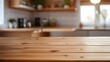 © phurimart - Wooden table on blurred kitchen bench background. Empty wooden table and blurred kitchen background