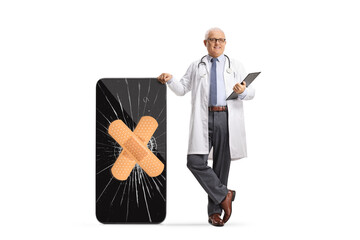 Wall Mural - Doctor with a broken smartphone and bandage on a cracked screen