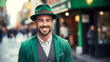 Modern hipster man in green St. Patrick's Day hat, against backdrop of city street decorated with green garlands