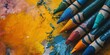 colorful crayons on the paper background