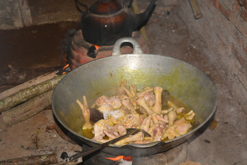 Close up photo of the process of cooking chicken in traditional Indonesian cooking