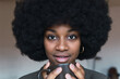 © ADDICTIVE STOCK - Positive black woman with hot beverage