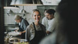 © ADDICTIVE STOCK - Confident female chef in a busy restaurant kitchen. Generative AI image