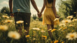 A couple in love holding hands in a daisy field on a warm summer afternoon. An atmosphere of coziness, love and mutual understanding