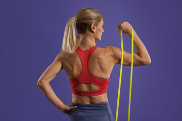 Poster - Athletic woman exercising with elastic resistance band on purple background, back view