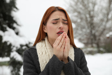 Poster - Beautiful young woman coughing outdoors. Cold symptoms