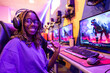closeup portrait of young african american gamer with glasses and braided hair looking at camera gesturing that she is ready to start online battle