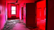 A rundown apartment room is bathed in a blood aura red light with multiple doors