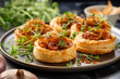 Caramelized onion puff pastry bites on a plate. Horizontal, close-up, side view.