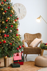 Poster - Interior of living room with glowing Christmas tree, armchair and lamp