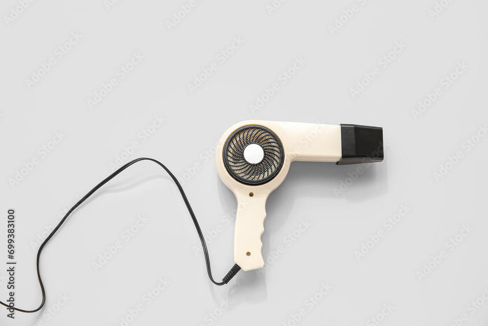 Hair dryer on light background