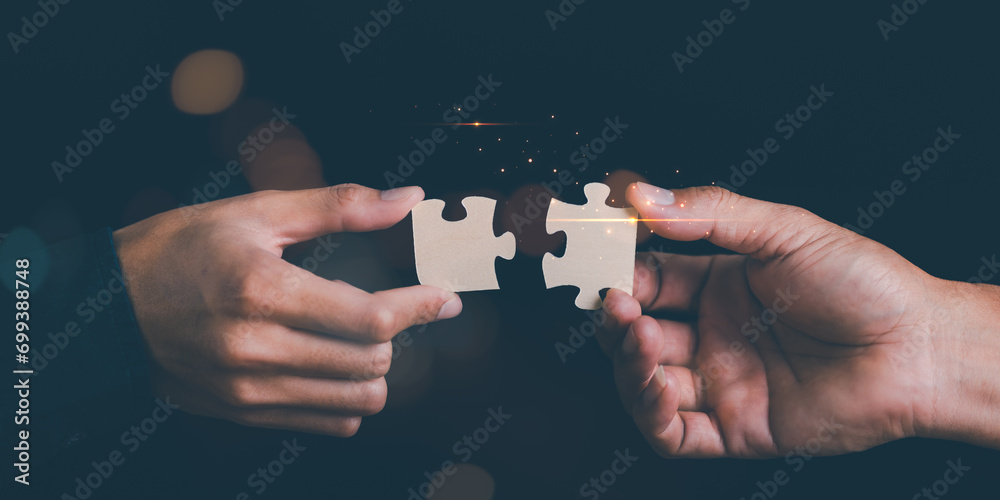 Businessman holding a puzzle piece to find a business solution ...